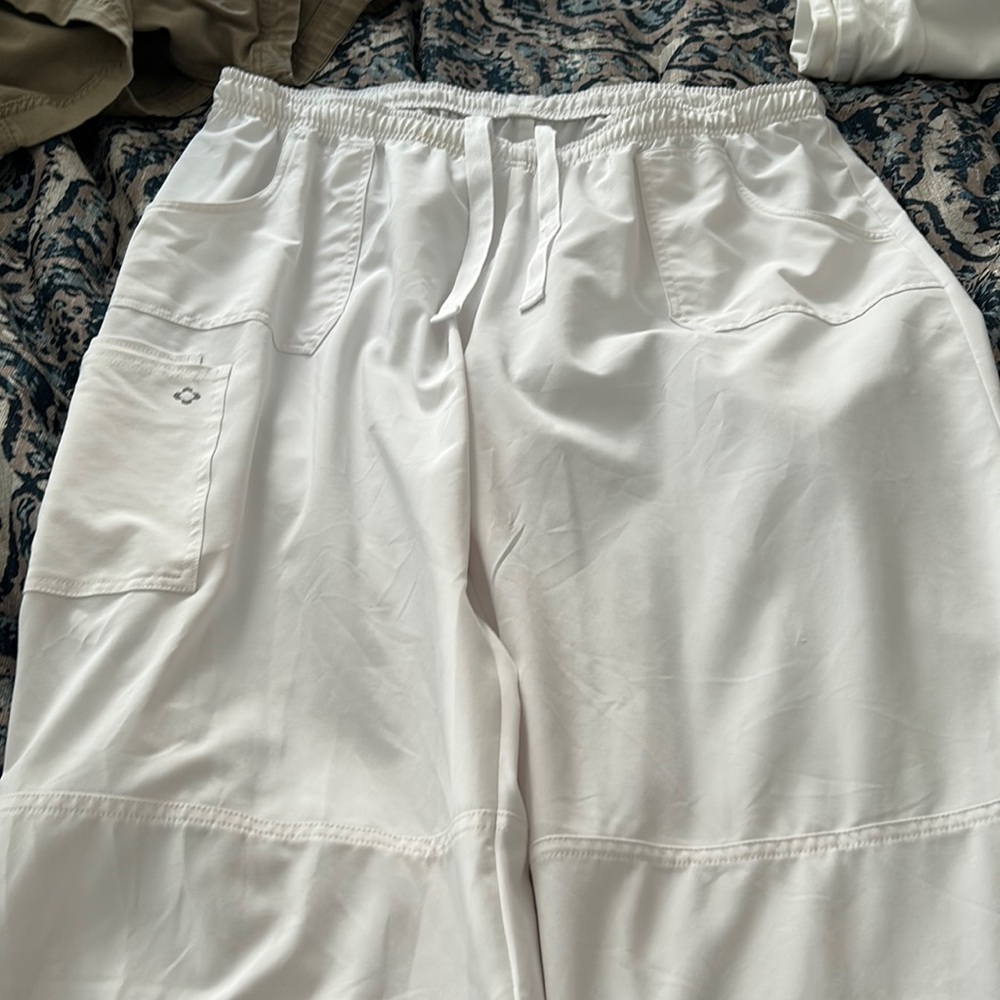 White scrub pants with elastic/drawstring waist and cargo pockets on right leg